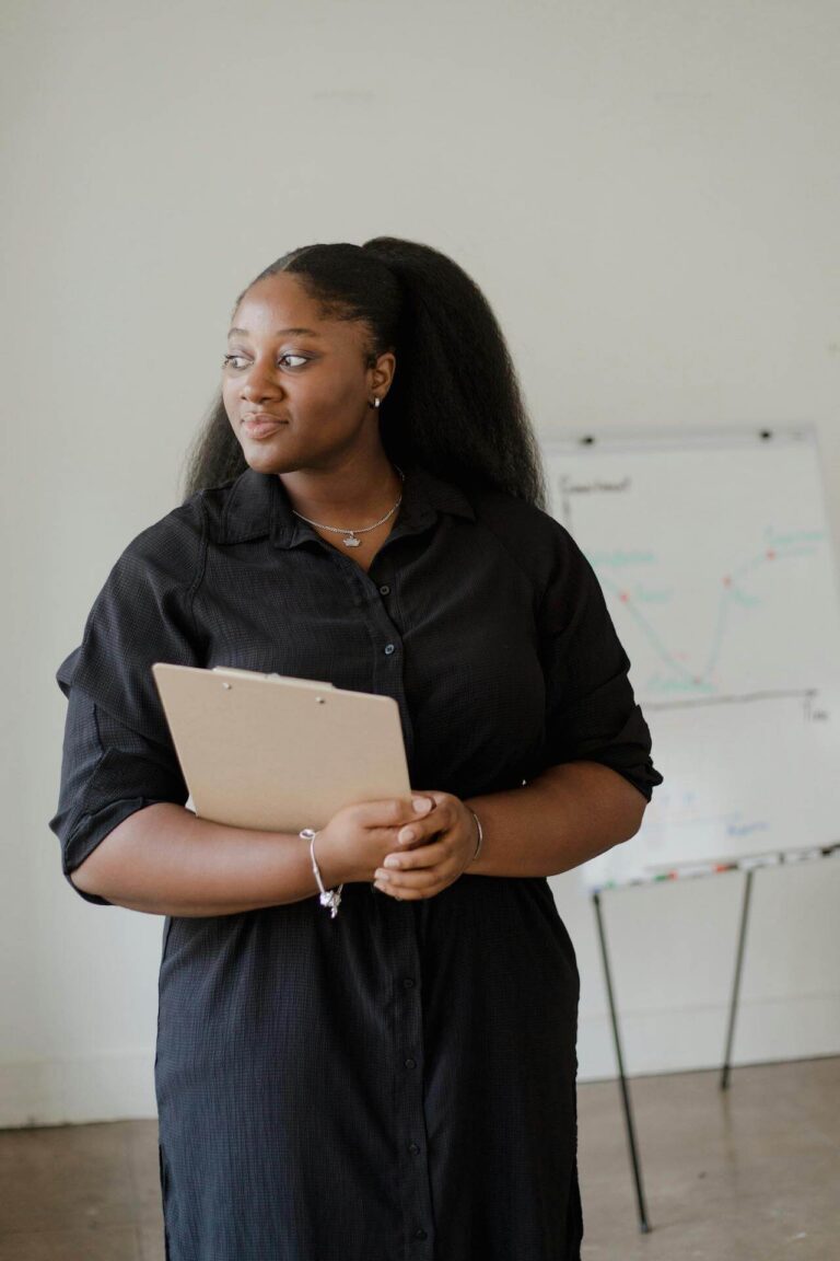 woman in black holding clipboard